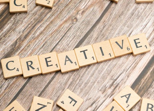 scrabble tiles spelling out the word creative