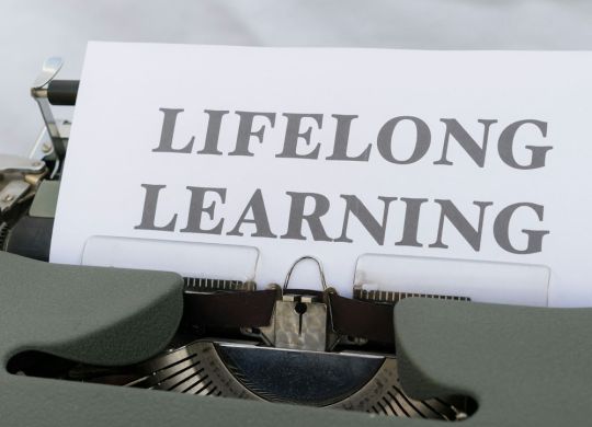 a close up of a typewriter with a sign on it