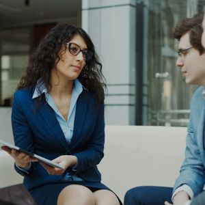 Three professionals in a business meeting discussion
