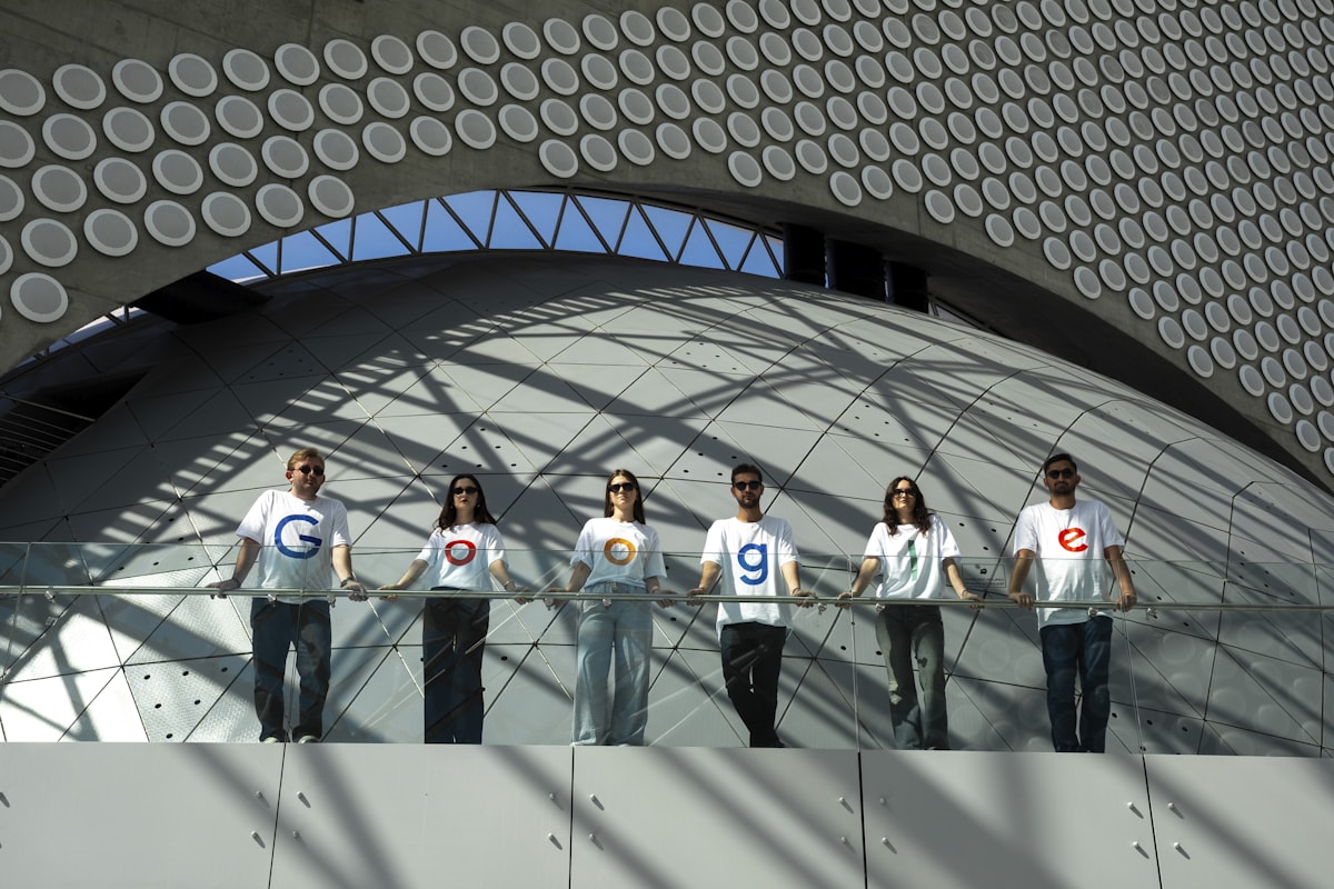 People wearing shirts with google logo and numbers