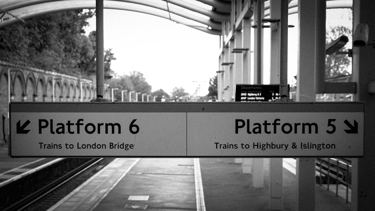 a black and white photo of a train platform
